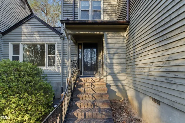 an empty room with floor to ceiling window and fireplace