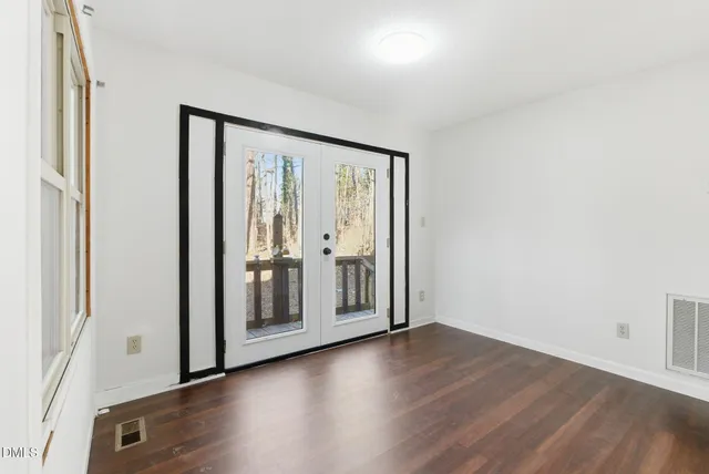 a view of a kitchen with wooden floor and electronic appliances