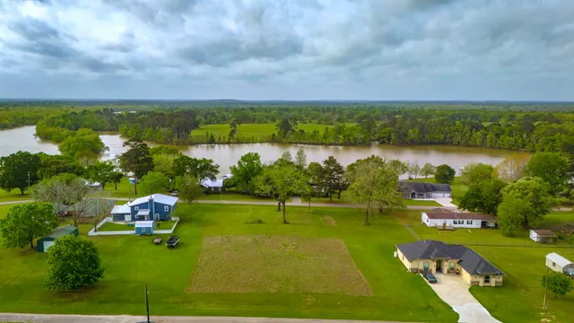 a view of a lake with houses in back