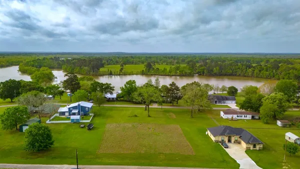 a view of a lake with houses in back