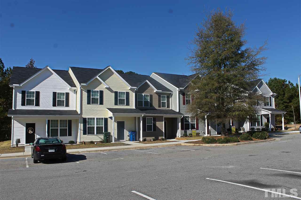 3908 Volkswalk Place Raleigh, NC 27610 - Photo 1 of 20 a view of a white house with large windows next to a road