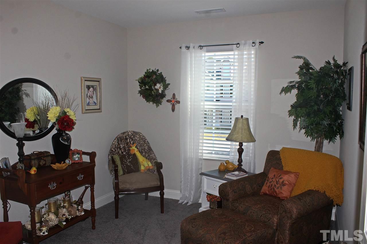 3908 Volkswalk Place Raleigh, NC 27610 - Photo 13 of 20 a living room with furniture and a window