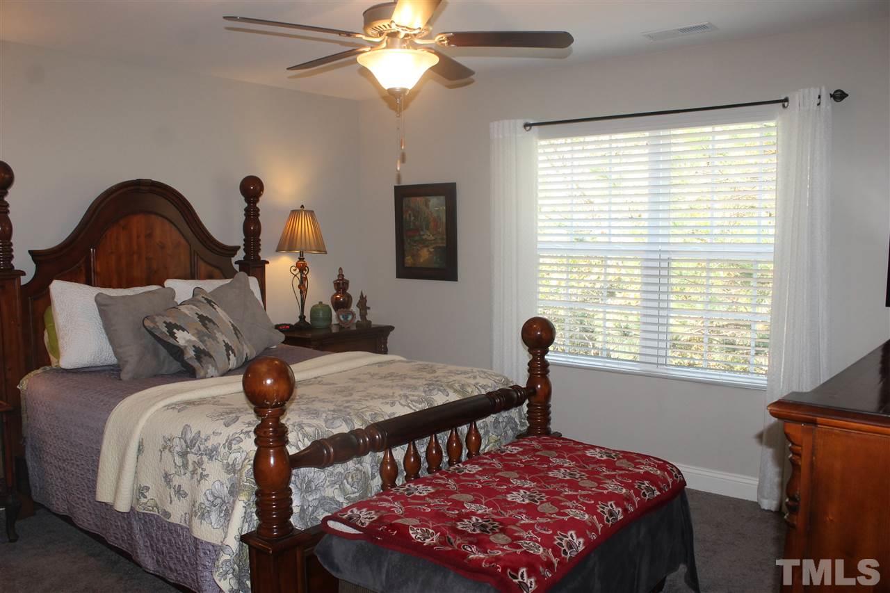 3908 Volkswalk Place Raleigh, NC 27610 - Photo 17 of 20 a bedroom with a bed and a window