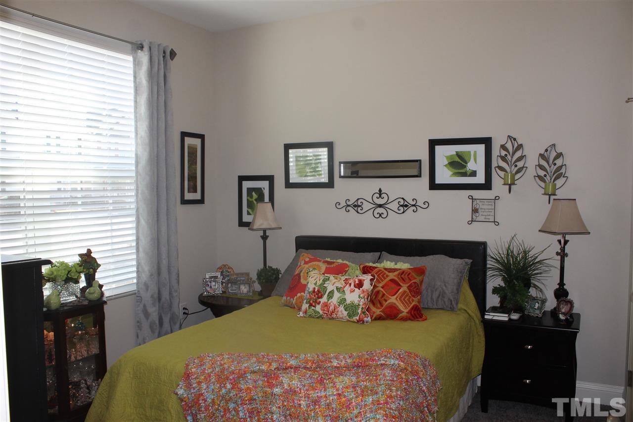 3908 Volkswalk Place Raleigh, NC 27610 - Photo 6 of 20 a bedroom with a bed and a lamp on dresser