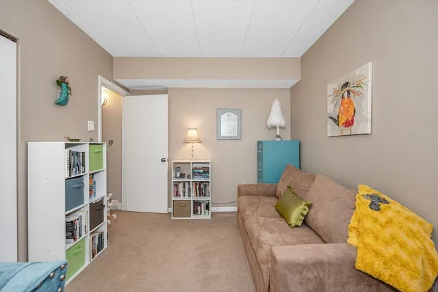 a living room with furniture and a book shelf