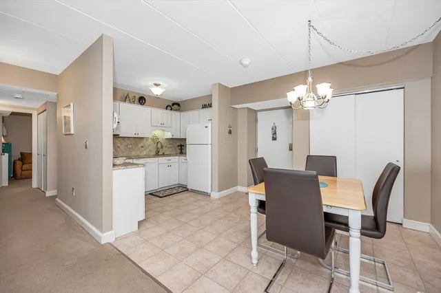 a view of a dining room with furniture and chandelier