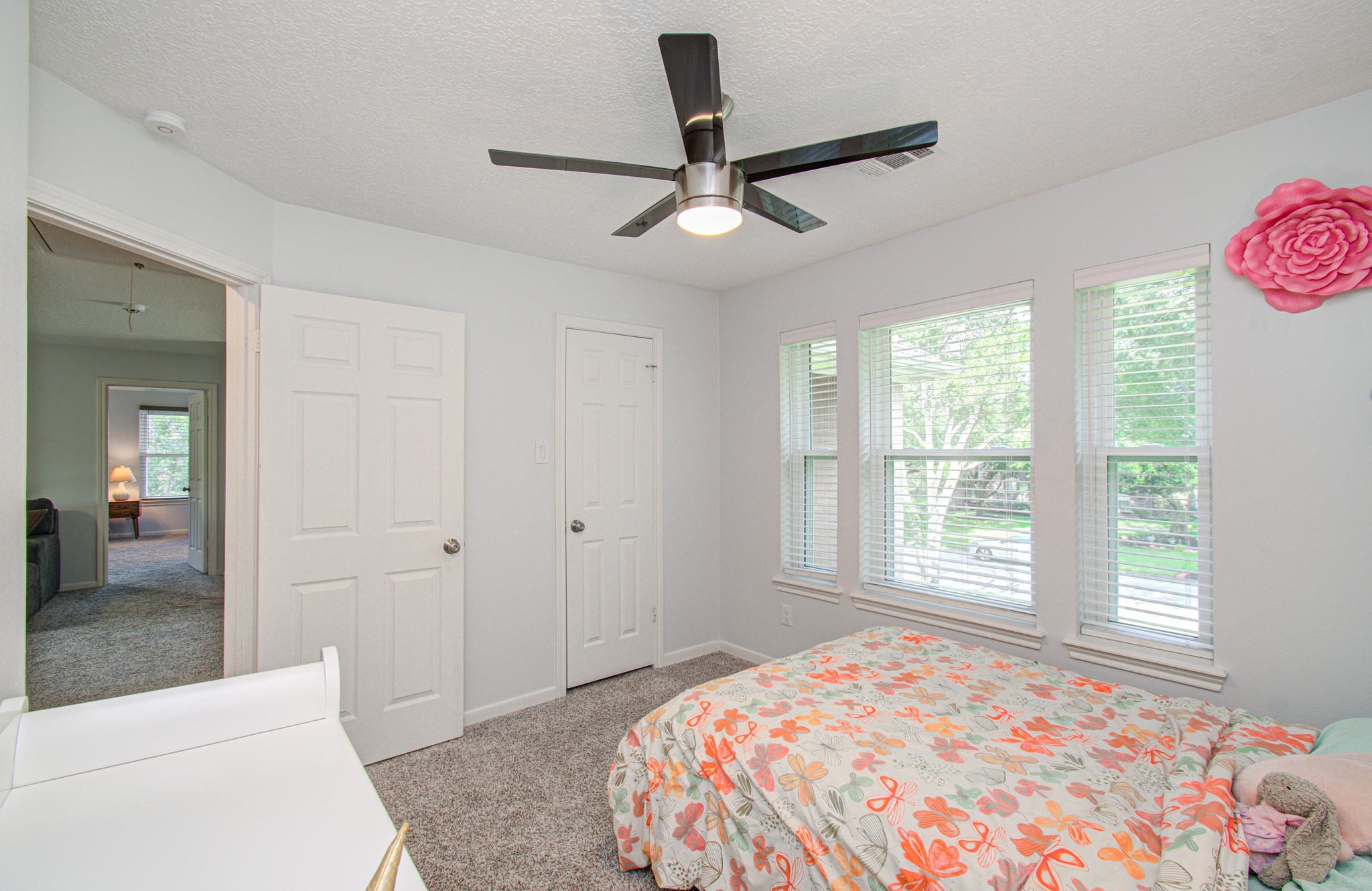 22927 Northoak Forest Lane Spring, TX 77389 - Photo 22 of 37 a bedroom with a bed and a chandelier