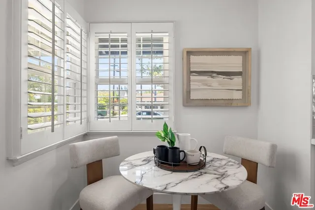 a dining room with furniture and window