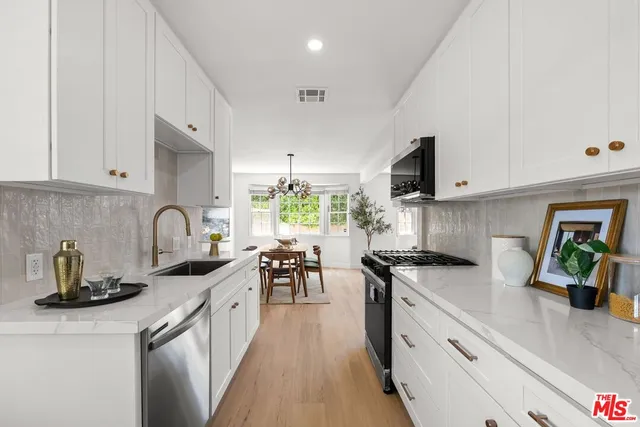 a kitchen with lots of counter top space cabinets and a sink