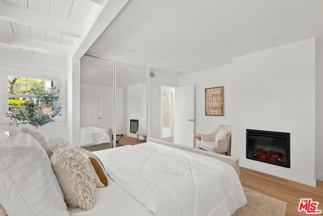 a bedroom with a bed and a fireplace