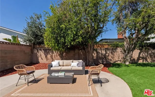 a backyard of a house with table and chairs