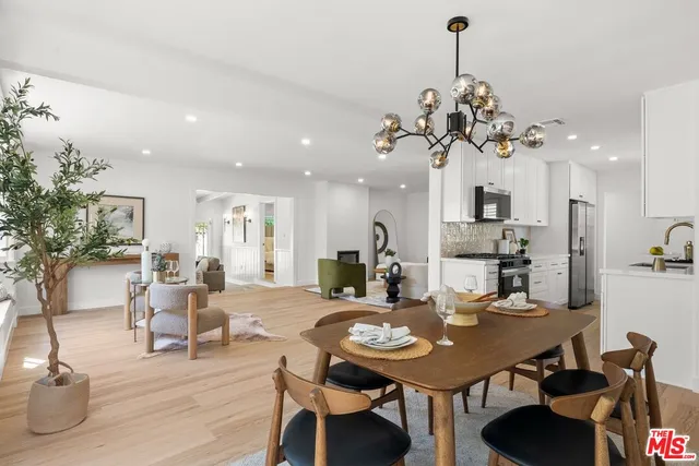 a view of a dining room and livingroom with furniture and wooden floor