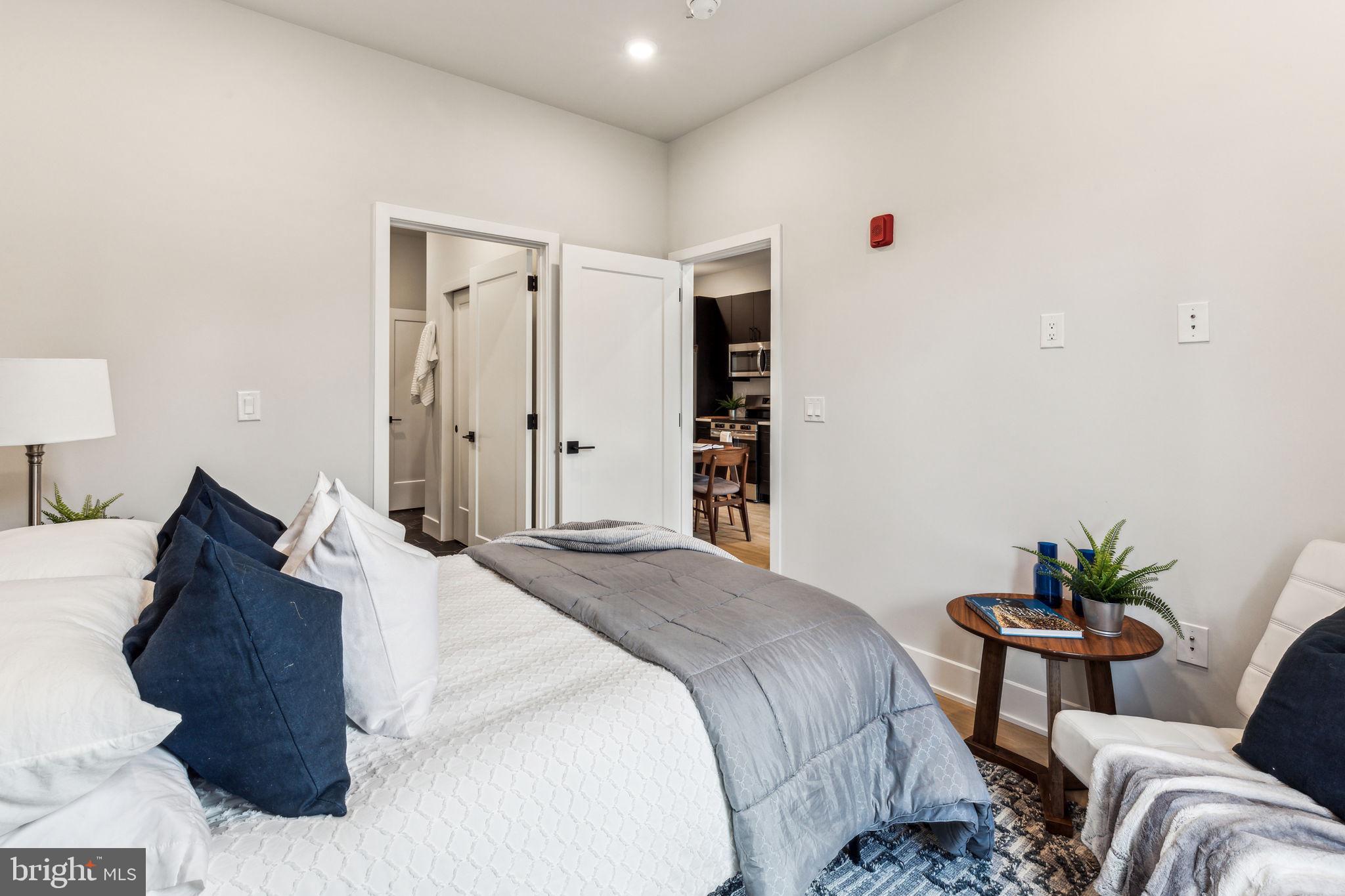 6910 Ridge Avenue, Unit 319 Philadelphia, PA 19128 - Photo 14 of 20 a bedroom with a bed and a couch