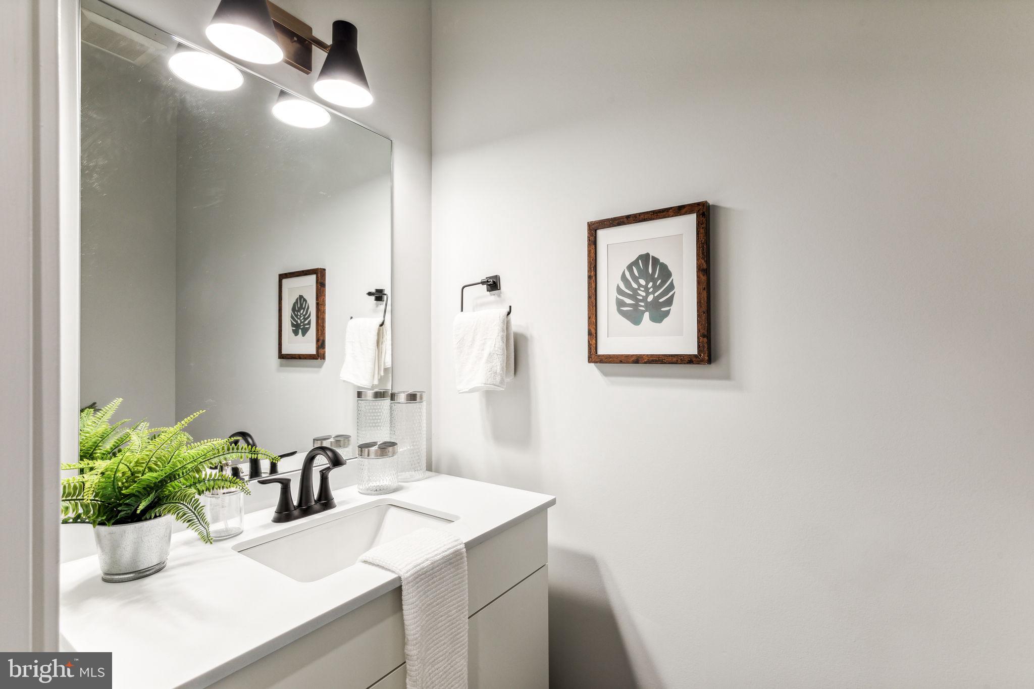 6910 Ridge Avenue, Unit 319 Philadelphia, PA 19128 - Photo 16 of 20 a bathroom with a sink mirror and vanity