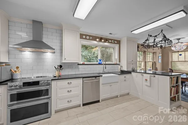 a kitchen with granite countertop a sink cabinets and window