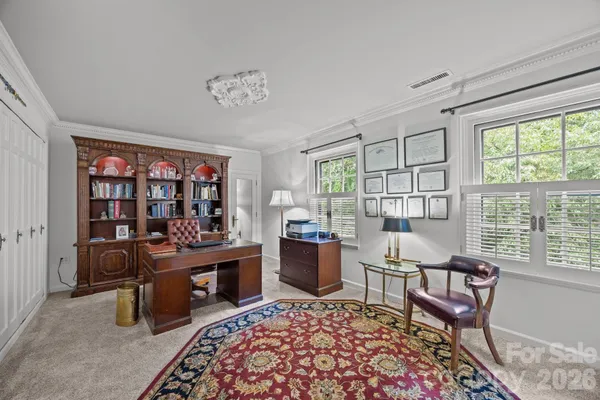 a living room with furniture a table and a large window