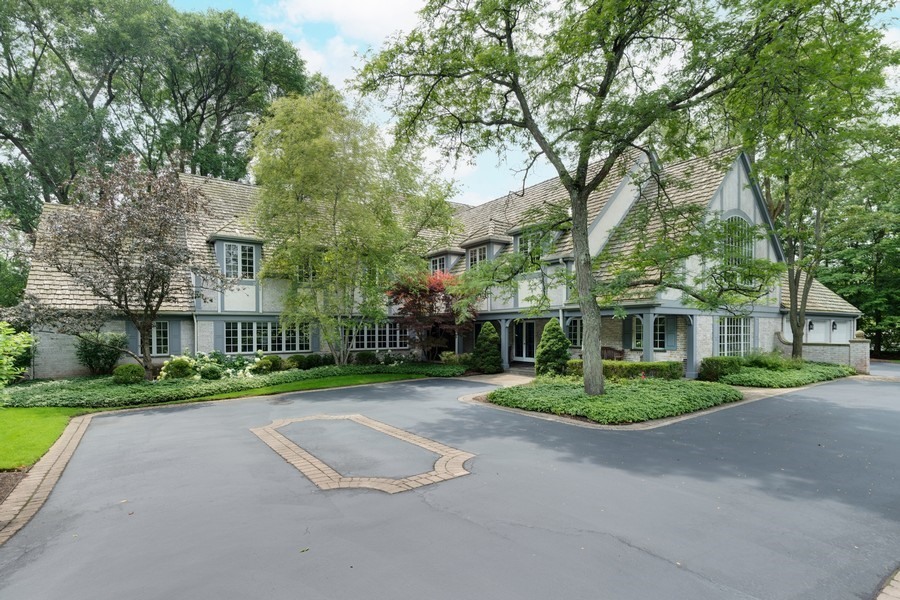 340 Old Farm Road Northfield, IL 60093 - Photo 1 of 50 a front view of a house with a yard and trees