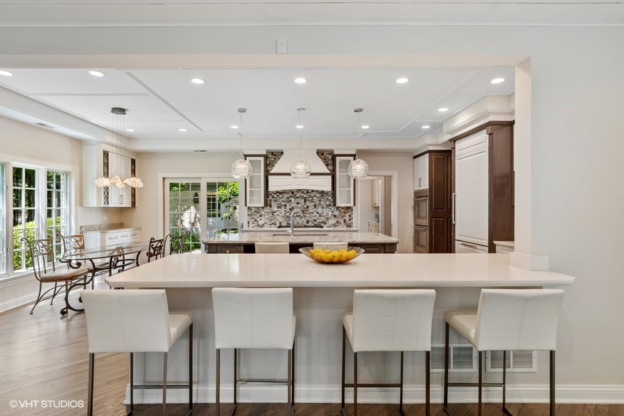 340 Old Farm Road Northfield, IL 60093 - Photo 15 of 50 a kitchen with stainless steel appliances granite countertop a dining table and chairs