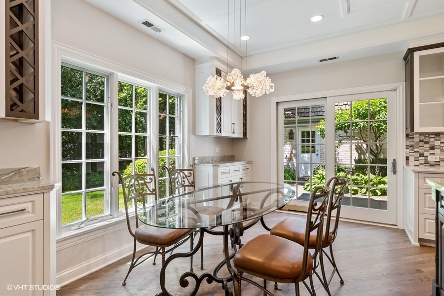 340 Old Farm Road Northfield, IL 60093 - Photo 17 of 50 a view of a dining room with furniture and a potted plant