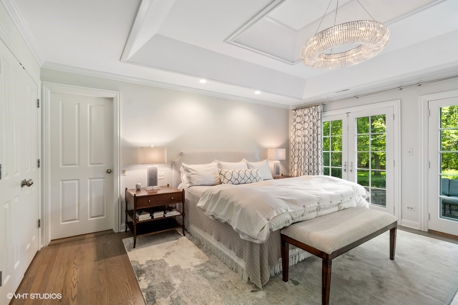 340 Old Farm Road Northfield, IL 60093 - Photo 23 of 50 a bedroom with a bed and a chandelier