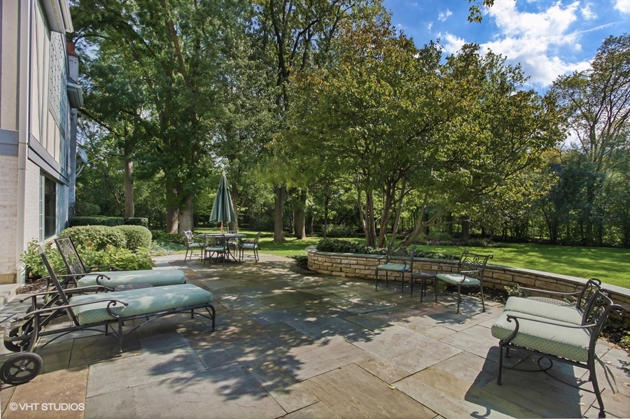 340 Old Farm Road Northfield, IL 60093 - Photo 42 of 50 a view of a backyard with lawn chairs and a fire pit