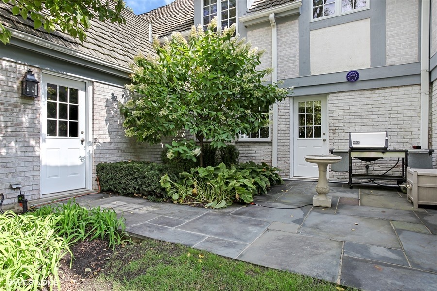 340 Old Farm Road Northfield, IL 60093 - Photo 44 of 50 a view of a house with backyard sitting area and garden