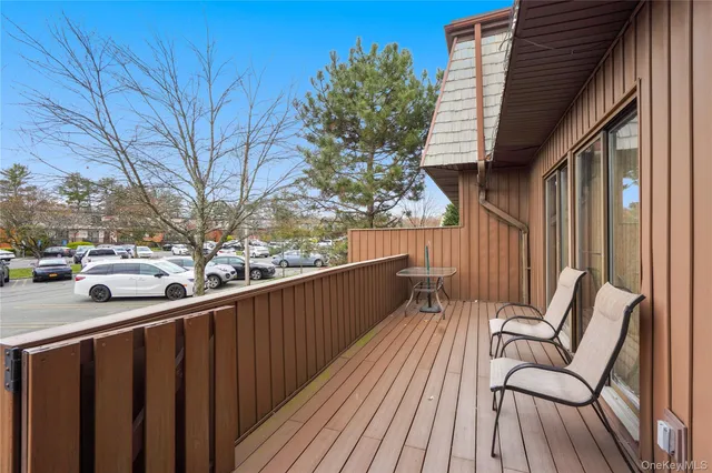 a view of balcony with wooden floor and seating space