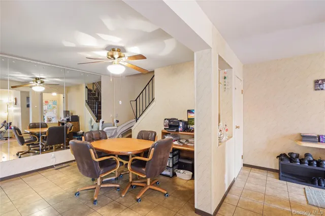 a dining room with furniture and a flat screen tv