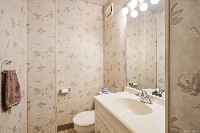 a dining room with furniture and a chandelier fan