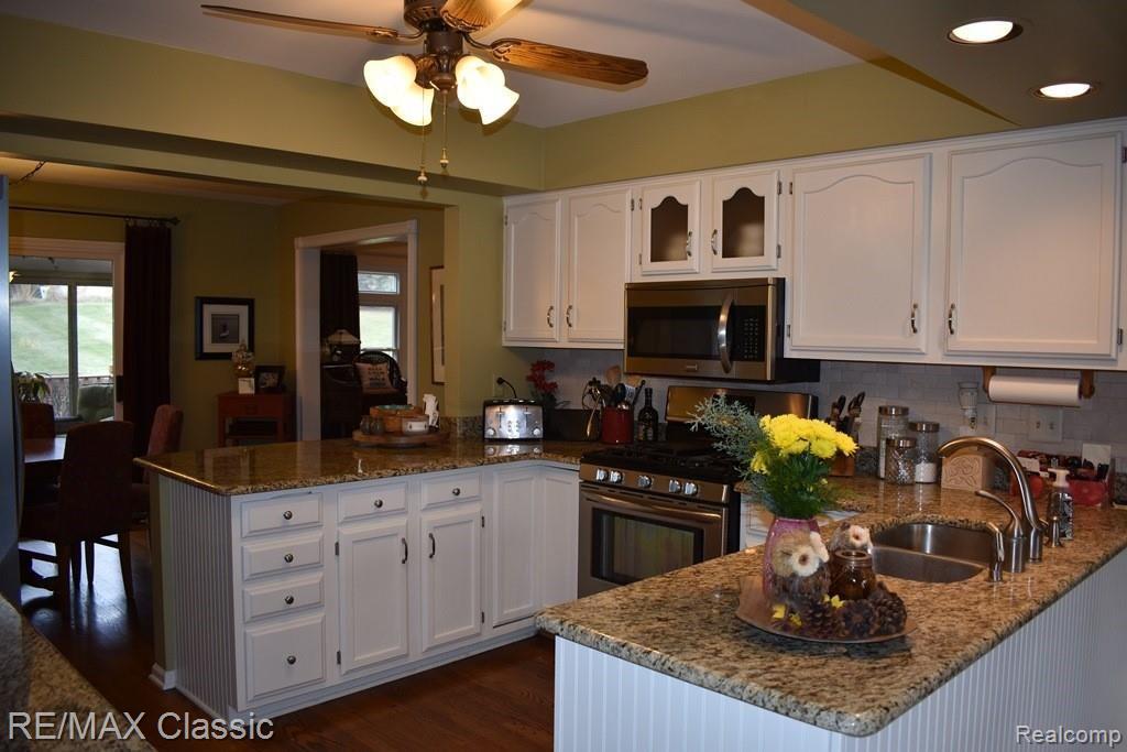 365 East Dawson Road Milford, MI 48381 - Photo 8 of 57 Kitchen with hardwood floor and granite counters.