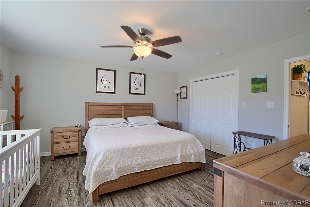 4944 Chestnut Fork Road Gloucester, VA 23061 - Photo 23 of 32 Bedroom featuring dark hardwood / wood-style floors, ceiling fan, and a closet