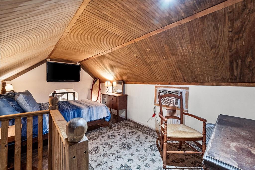 14036 Old Texaco Road Conroe, TX 77302 - Photo 23 of 40 Bedroom featuring wood ceiling and vaulted ceiling