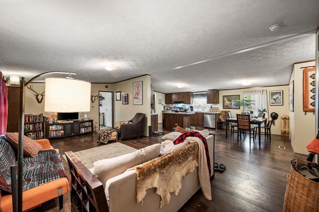 14036 Old Texaco Road Conroe, TX 77302 - Photo 25 of 40 Living area featuring dark wood finished floors and a textured ceiling