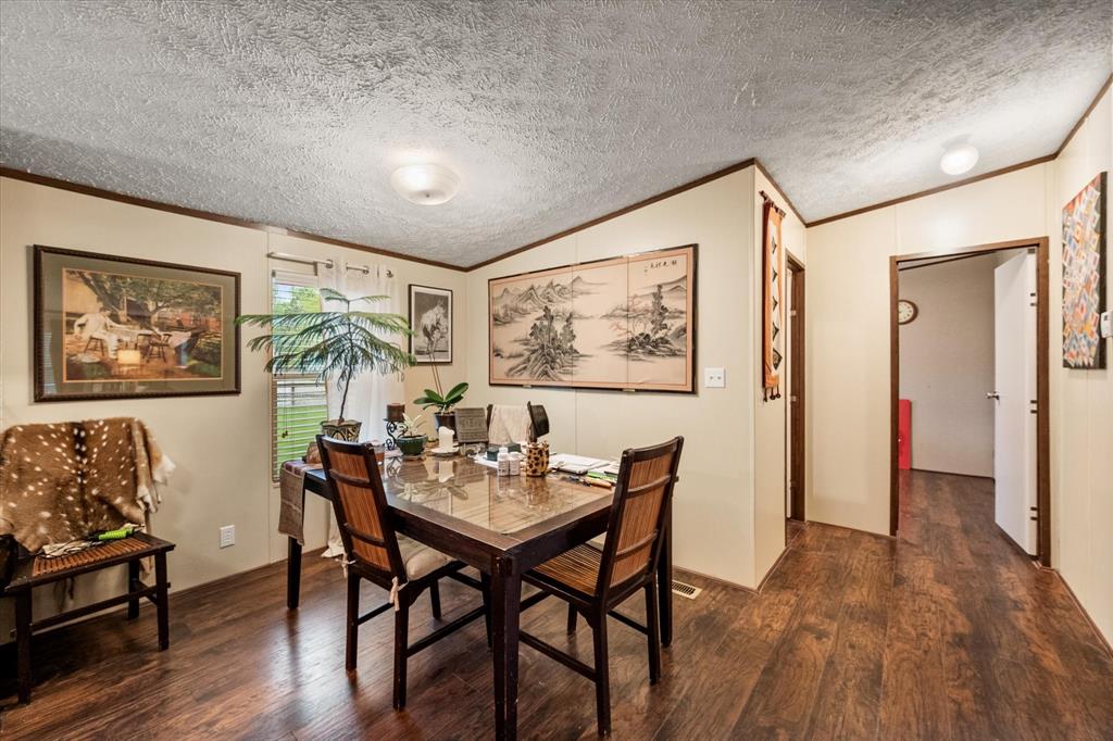 14036 Old Texaco Road Conroe, TX 77302 - Photo 27 of 40 Dining space with ornamental molding, dark wood-type flooring, and vaulted ceiling