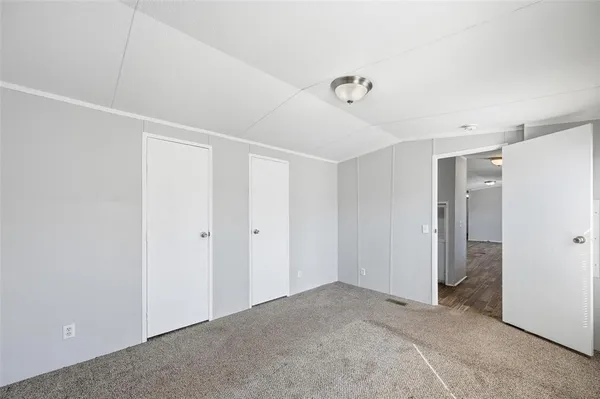 a view of a big room with closet and windows