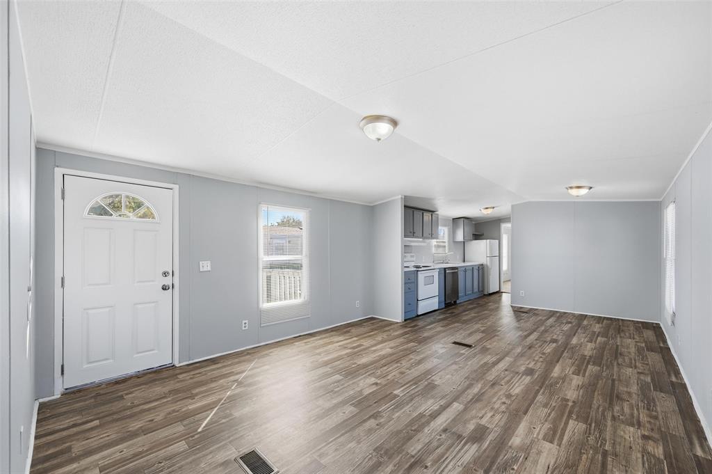 607 Keats Road Wilmer, TX 75172 - Photo 7 of 27 a view of empty room with wooden floor and window