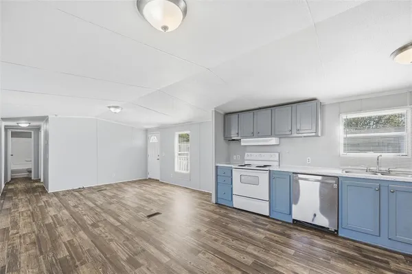 a kitchen with stainless steel appliances granite countertop a stove and a sink