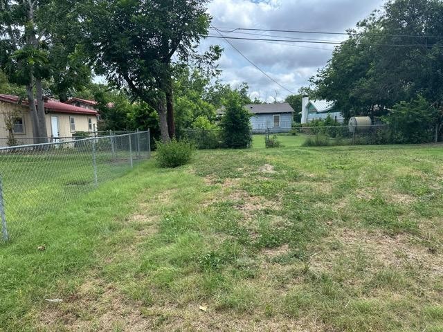 408 Ruth Street Kerrville, TX 78028 - Photo 12 of 12 a backyard of a house with plants and large trees