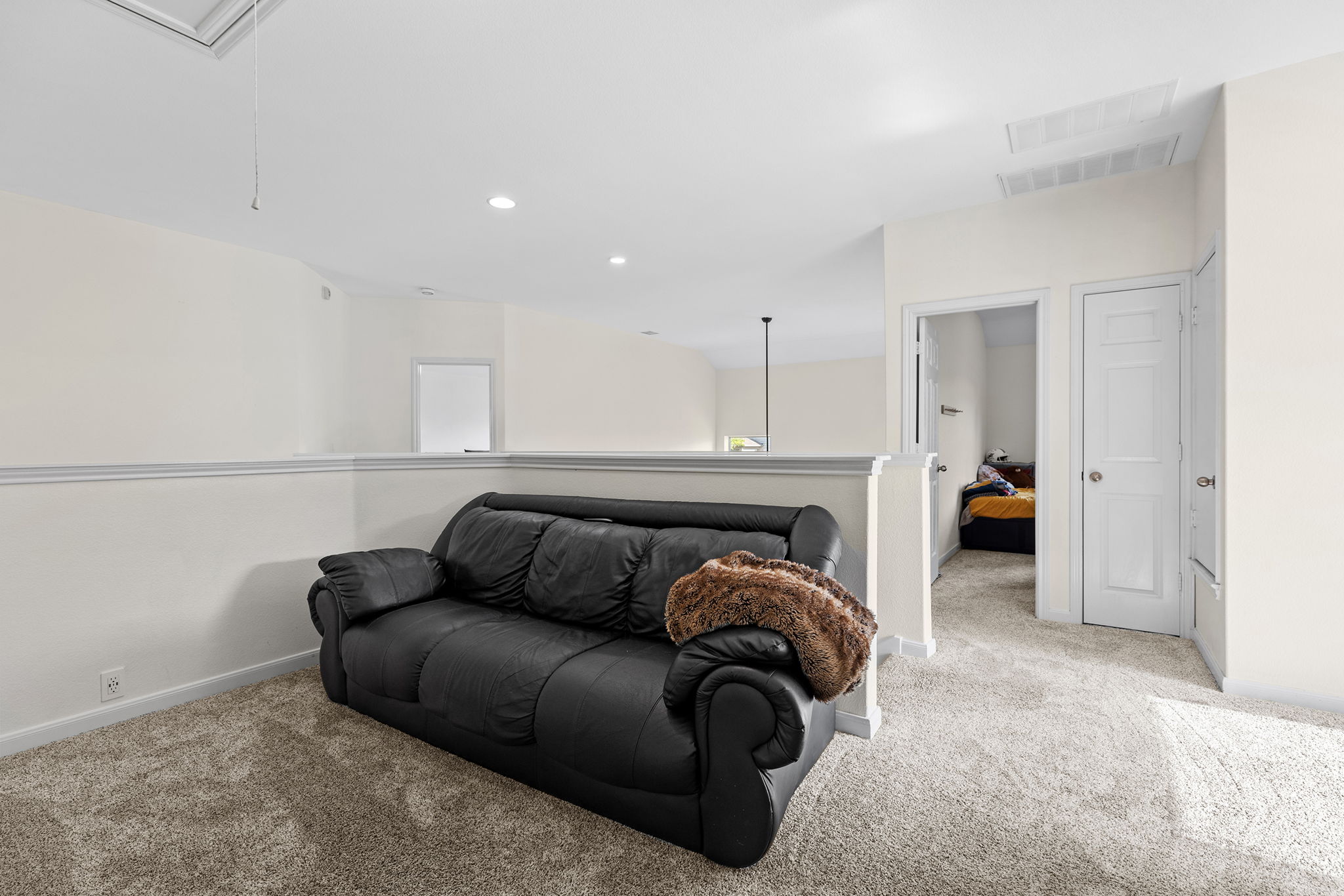 3517 Shiraz Loop Round Rock, TX 78665 - Photo 21 of 40 Carpeted loft area featuring a half-wall railing, recessed lighting, white trim, and a white paneled door
