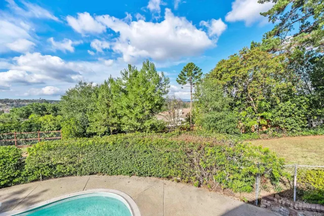 a kitchen with stainless steel appliances granite countertop a refrigerator a sink dishwasher a stove and white countertops with wooden floor