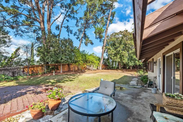 a kitchen with wooden floors and white walls