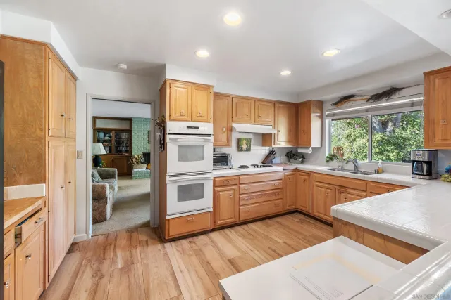 a kitchen with stainless steel appliances a refrigerator stove and cabinets