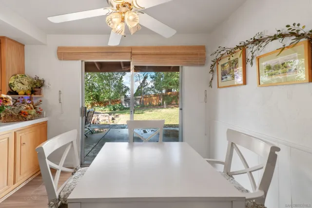 a view of a dining room with furniture a chandelier and wooden floor