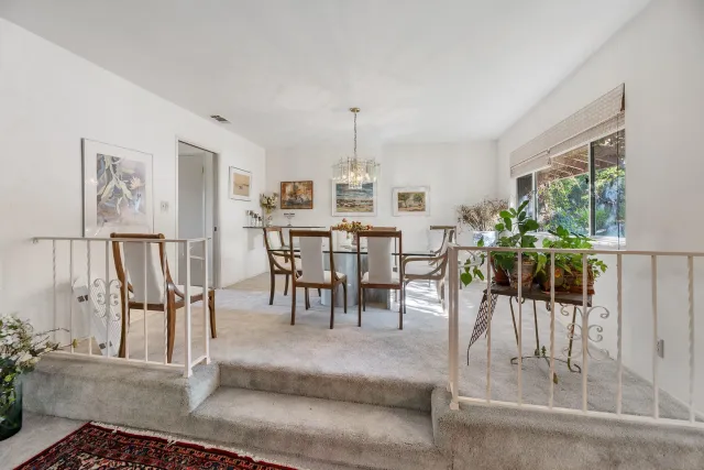 a view of a livingroom with workspace and a window