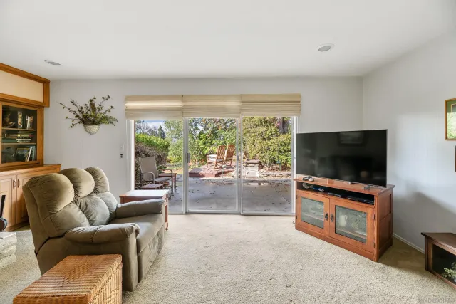 a bedroom with furniture and a large window
