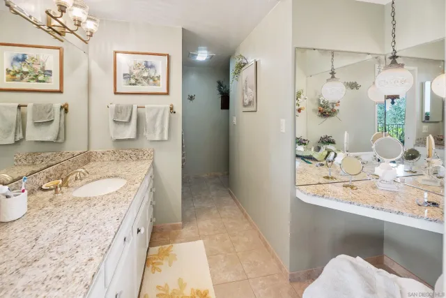 a backyard of a house with large trees and outdoor seating