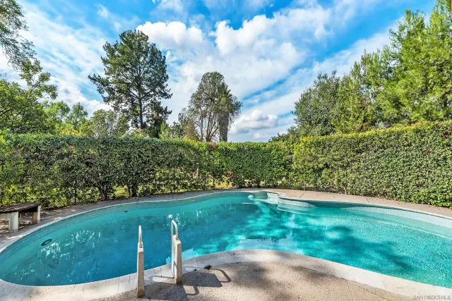 a living room with furniture pool table and flat screen tv
