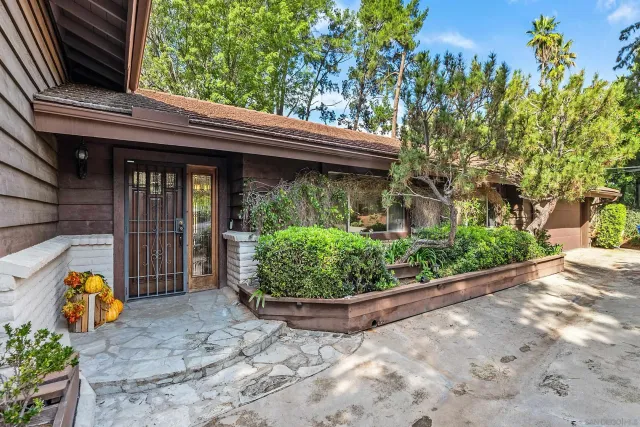 an aerial view of a house with a swimming pool and outdoor space