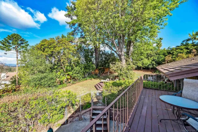 a view of a backyard with plants and patio