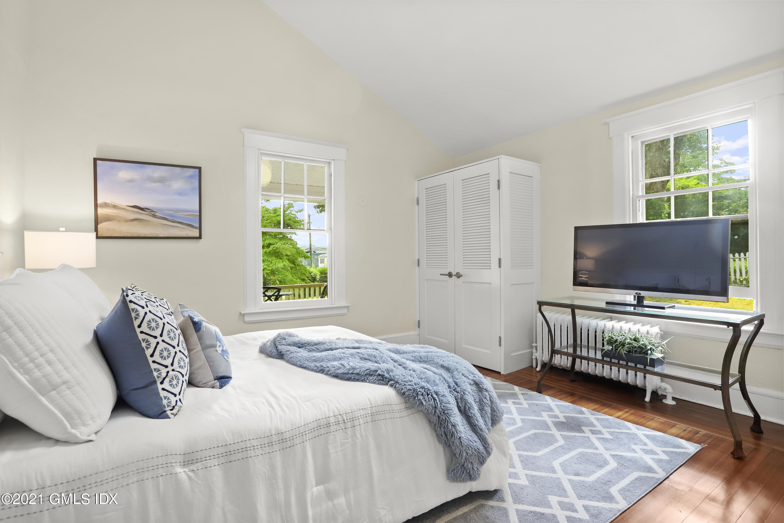 35 Strickland Road Cos Cob, CT 06807 - Photo 16 of 25 a bedroom with a bed and flat screen tv
